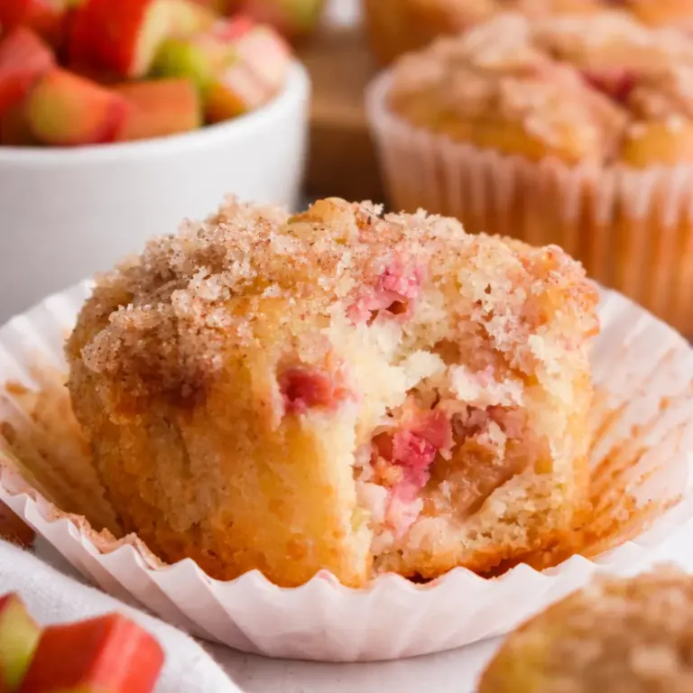 Delicious and fluffy Rhubarb Muffins with crunchy brown sugar topping and fresh rhubarb.